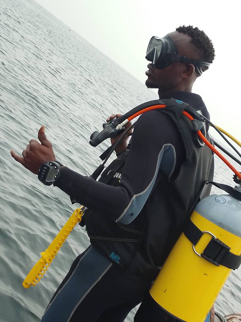 Diver on the boat, ocean behind