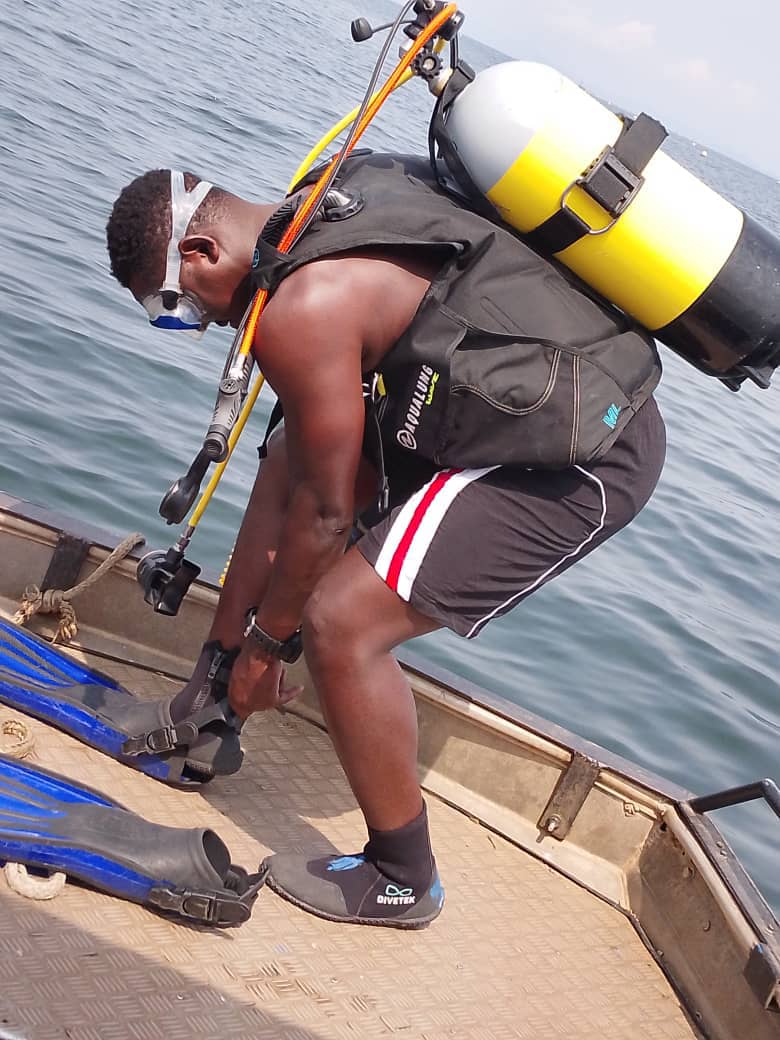 Diver preparing fins on the boat
