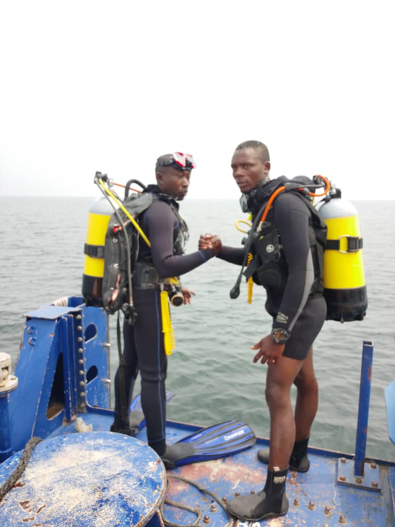 Close-up of diver adjusting fin